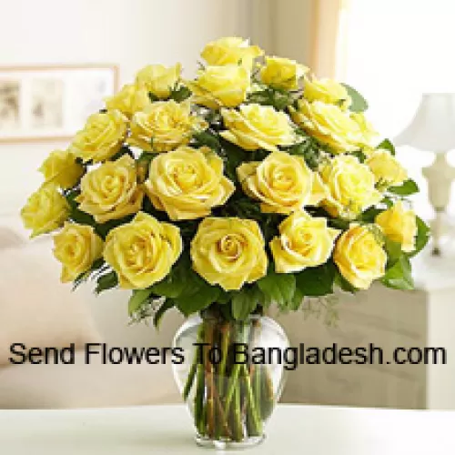 24 Yellow Roses With Some Ferns In A Glass Vase