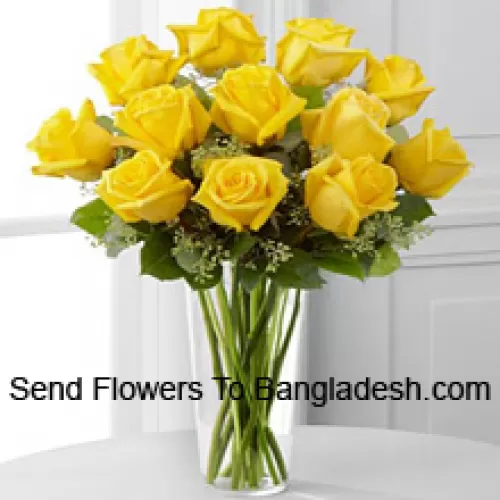 12 Yellow Roses With Some Ferns In A Glass Vase