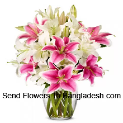 White And Pink Lilies With Some Ferns In A Glass Vase