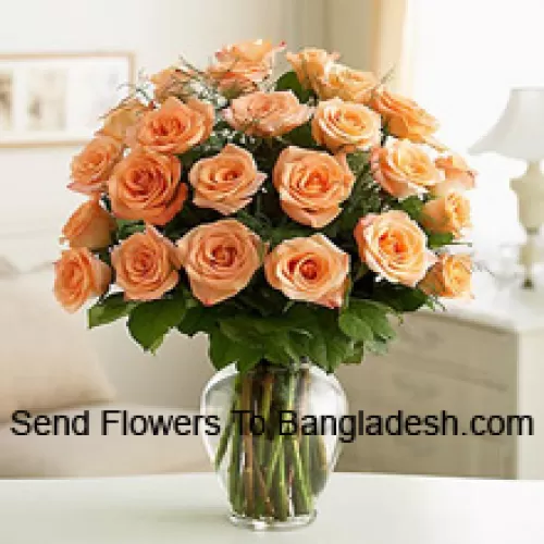 24 Peach Roses With Some Ferns In A Glass Vase